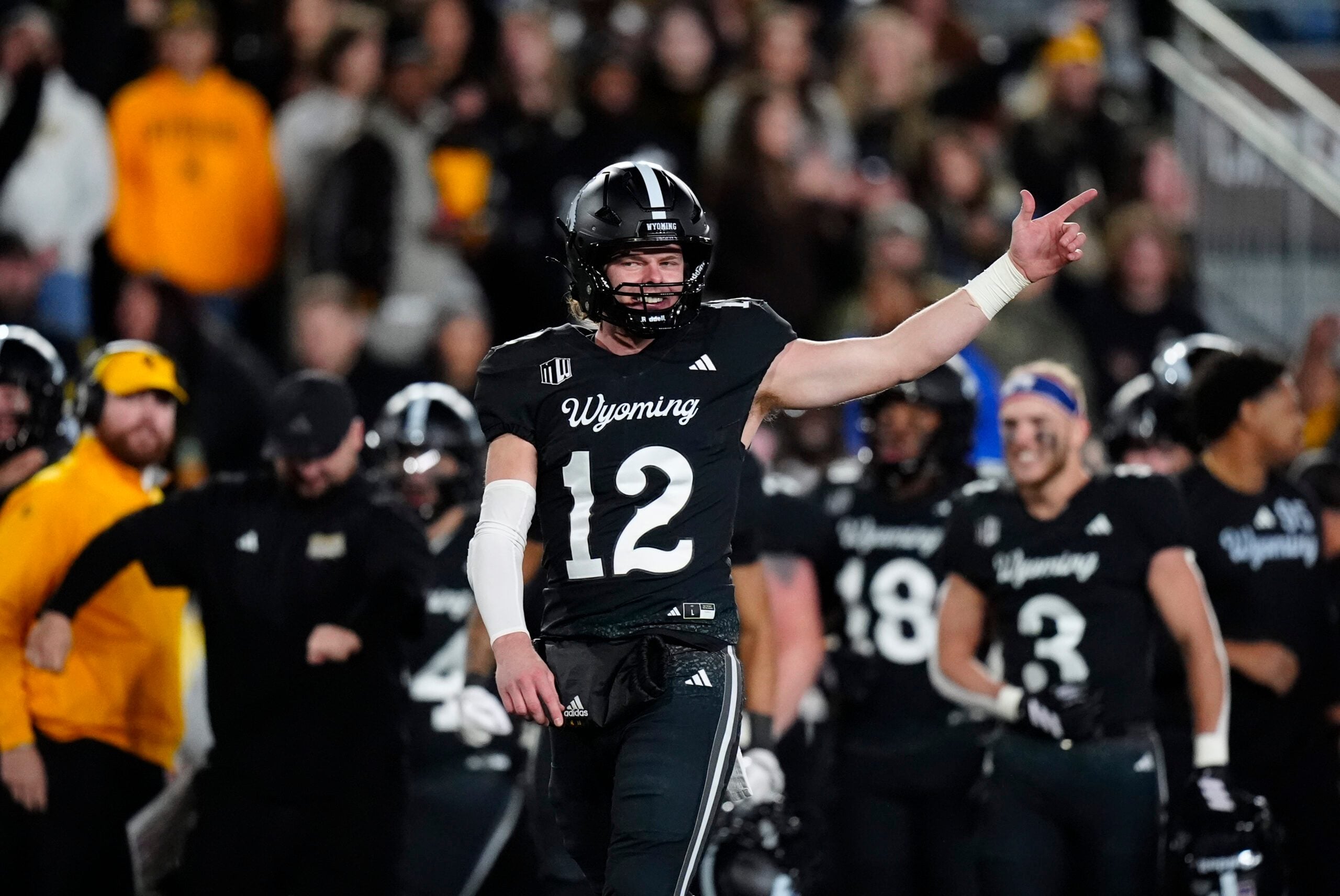 Oct 25, 2025; Laramie, Wyoming, USA; Wyoming Cowboys quarterback Kaden Anderson (12) celebrates a turnover on downs by the Colorado State Rams during the fourth quarter at Jonah Field at War Memorial Stadium. Mandatory Credit: Ron Chenoy-Imagn Images