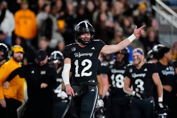 Oct 25, 2025; Laramie, Wyoming, USA; Wyoming Cowboys quarterback Kaden Anderson (12) celebrates a turnover on downs by the Colorado State Rams during the fourth quarter at Jonah Field at War Memorial Stadium. Mandatory Credit: Ron Chenoy-Imagn Images