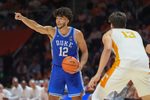 Duke forward Cameron Boozer (12) sends out instructions while guarded by Tennessee forward J.P. Estrella (13) during a college basketball exhibition game between on October 26, 2025, in Knoxville, Tenn.