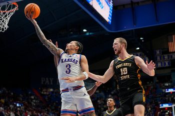 Oct 28, 2025; Lawrence, KS, USA; Kansas Jayhawks guard Tre White (3) shoots against Fort Hays State Tigers guard Blake Danitschek (10) during the second half at Allen Fieldhouse. Mandatory Credit: Jay Biggerstaff-Imagn Images