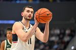 Oct 28, 2025; Hartford, CT, USA; Connecticut Huskies forward Alex Karaban (11) shoot a free throw during the first half against the Michigan State Spartans at PeoplesBank Arena. Mandatory Credit: Mark Smith-Imagn Images