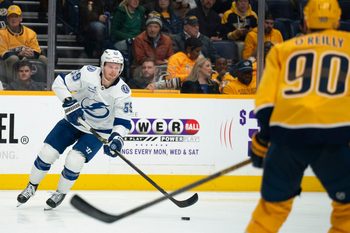 Tampa Bay center Jake Guentzel (59) handles the puck against Nashville center Ryan O'Reilly (90) during their game at Bridgestone Arena in Nashville, Tenn., Tuesday, Oct. 28, 2025.
