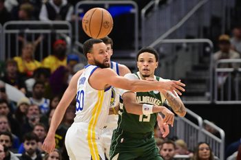 Oct 30, 2025; Milwaukee, Wisconsin, USA;  Milwaukee Bucks guard Ryan Rollins (13) passes the ball away from Golden State Warriors guard Stephen Curry (30) in the first quarter at Fiserv Forum. Mandatory Credit: Benny Sieu-Imagn Images