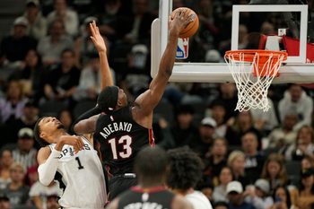 Oct 30, 2025; San Antonio, Texas, USA; Miami Heat forward Bam Adebayo (13) dunks ahead of San Antonio Spurs forward Victor Wembanyama (1) during the first at Frost Bank Center. Mandatory Credit: Scott Wachter-Imagn Images