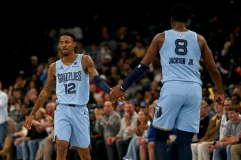 Oct 31, 2025; Memphis, Tennessee, USA; Memphis Grizzlies guard Ja Morant (12) reacts with forward/center Jaren Jackson Jr. (8) during the first quarter against the Los Angeles Lakers at FedExForum. Mandatory Credit: Petre Thomas-Imagn Images