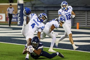 Oct 31, 2025; Houston, Texas, USA; Memphis Tigers wide receiver Cortez Braham Jr. (4) is tackled by Rice Owls safety Marcus Williams (4) in the second half at Rice Stadium. Mandatory Credit: Thomas Shea-Imagn Images