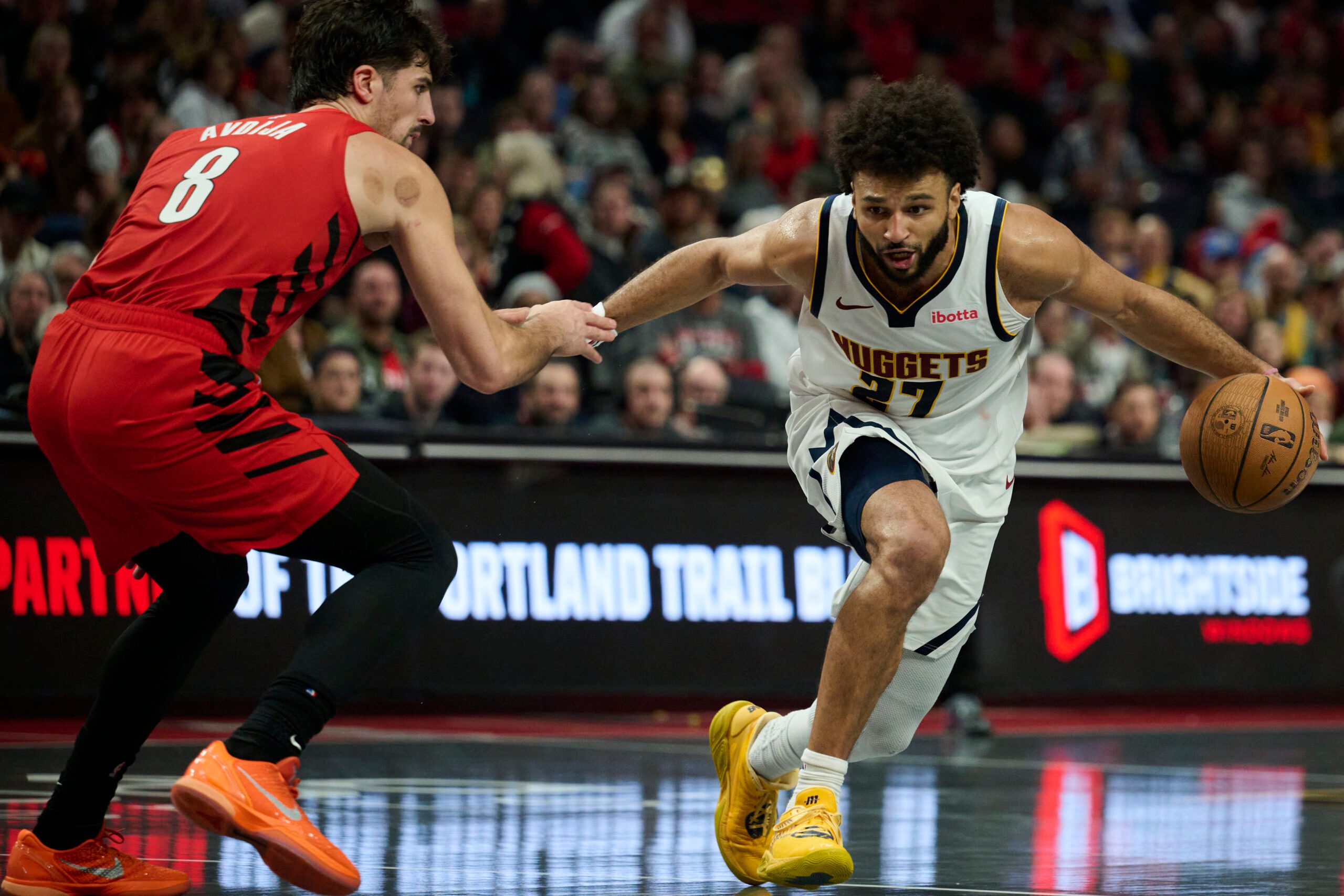 Oct 31, 2025; Portland, Oregon, USA; Denver Nuggets guard Jamal Murray (27) dribbles the ball during the second half against Portland Trail Blazers forward Deni Avdija (8) at Moda Center. Mandatory Credit: Troy Wayrynen-Imagn Images