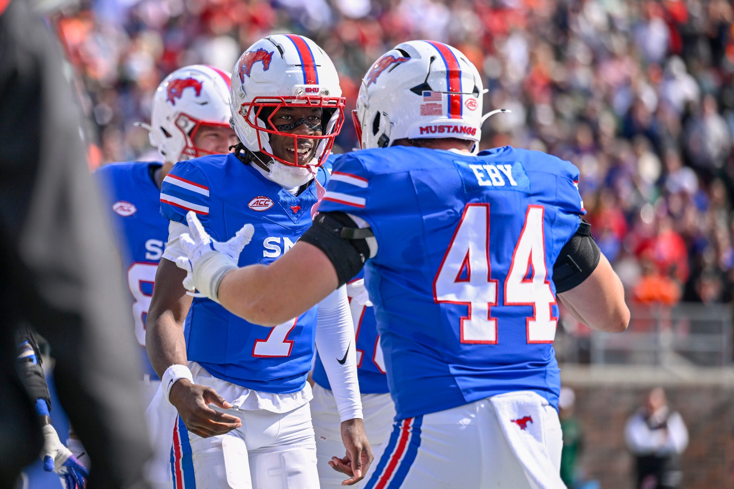 Nov 1, 2025; Dallas, Texas, USA;  SMU Mustangs quarterback Kevin Jennings (7) and tight end Stone Eby (44) celebrates after Jennings scores a touchdown against the Miami Hurricanes during the second half at Gerald J. Ford Stadium. Mandatory Credit: Jerome Miron-Imagn Images