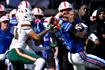 Nov 1, 2025; Dallas, Texas, USA;  SMU Mustangs wide receiver Jordan Hudson (2) catches a pass for a first down as he is tackled by Miami Hurricanes defensive back Ethan O'Connor (24) during the second half at Gerald J. Ford Stadium. Mandatory Credit: Jerome Miron-Imagn Images