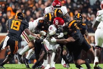Oklahoma running back Tory Blaylock (6) is warmped by Tennessee linebacker Edwin Spillman (13), Tennessee linebacker Arion Carter (7) and Tennessee defensive lineman Daevin Hobbs (5) during a NCAA football game between the Tennessee Volunteers and Oklahoma Sooners at Neyland Stadium in Knoxville, Tenn., on November 1, 2025.