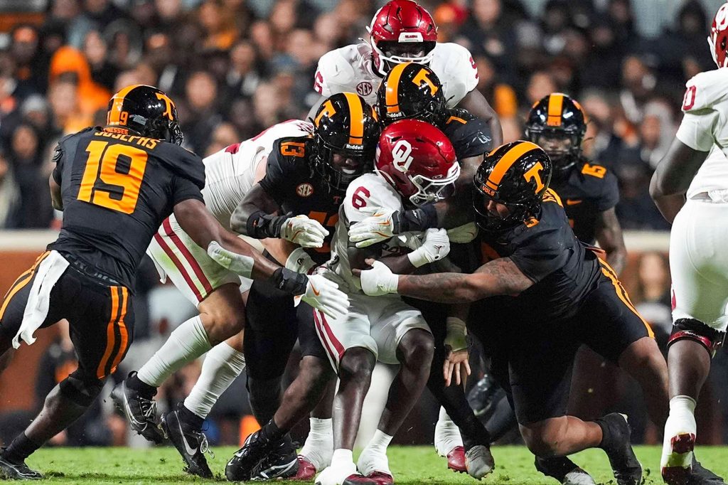 Oklahoma running back Tory Blaylock (6) is warmped by Tennessee linebacker Edwin Spillman (13), Tennessee linebacker Arion Carter (7) and Tennessee defensive lineman Daevin Hobbs (5) during a NCAA football game between the Tennessee Volunteers and Oklahoma Sooners at Neyland Stadium in Knoxville, Tenn., on November 1, 2025.