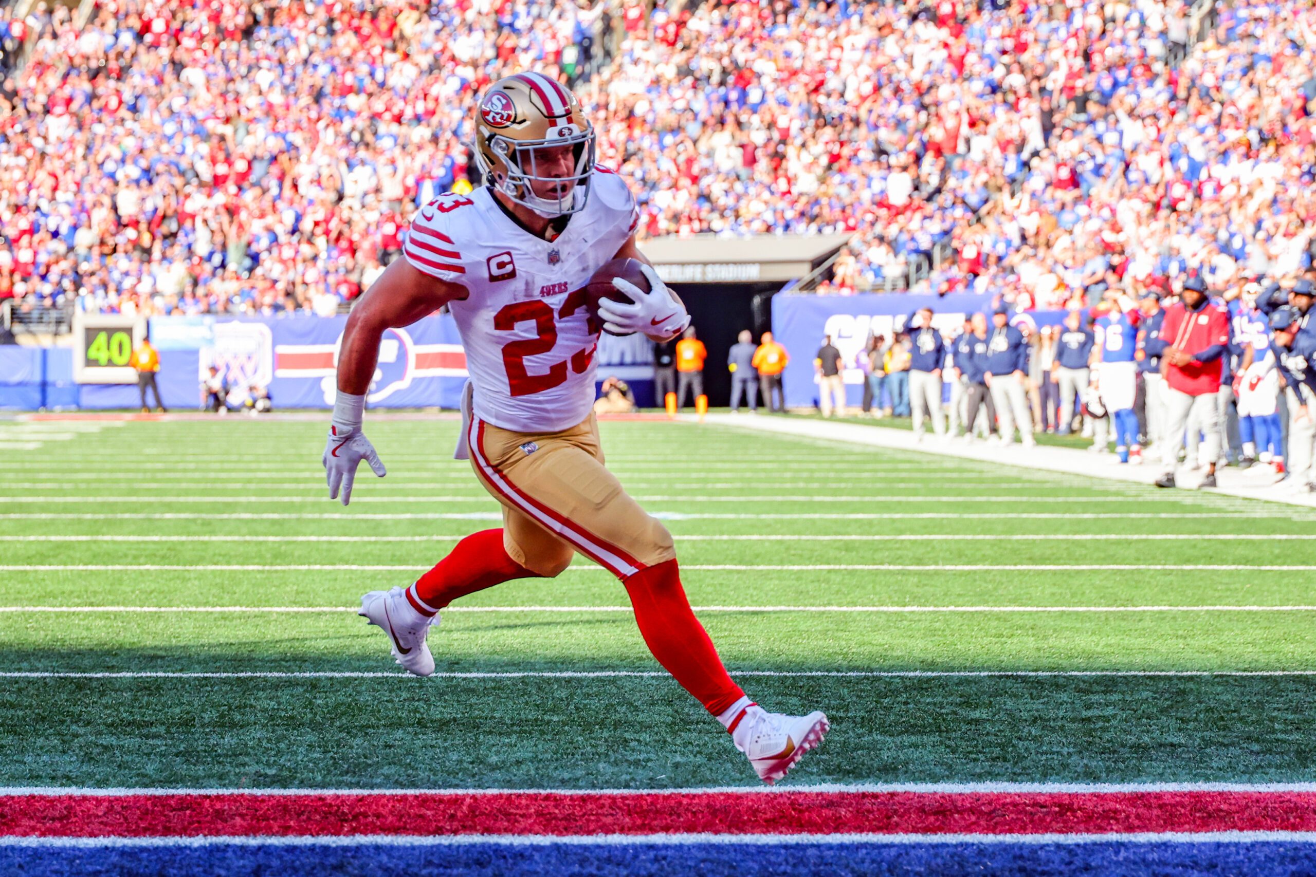 Nov 2, 2025; East Rutherford, New Jersey, USA; San Francisco 49ers running back Christian McCaffrey (23) runs after the catch for a touchdown against the New York Giants during the first half at MetLife Stadium. Mandatory Credit: Ed Mulholland-Imagn Images