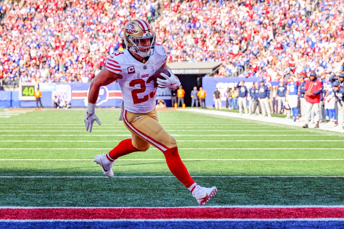 Nov 2, 2025; East Rutherford, New Jersey, USA; San Francisco 49ers running back Christian McCaffrey (23) runs after the catch for a touchdown against the New York Giants during the first half at MetLife Stadium. Mandatory Credit: Ed Mulholland-Imagn Images