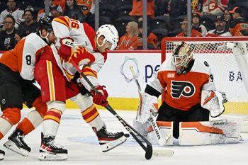 Nov 2, 2025; Philadelphia, Pennsylvania, USA; Philadelphia Flyers goaltender Aleksei Kolosov (35) makes a save agaijnst  Calgary Flames center Morgan Frost (16) during the first period at Xfinity Mobile Arena. Mandatory Credit: Eric Hartline-Imagn Images