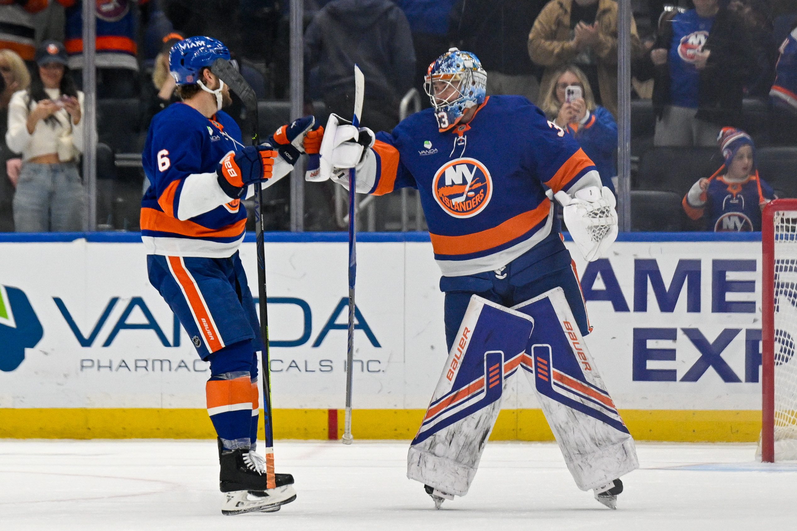 Nov 2, 2025; Elmont, New York, USA; New York Islanders defenseman Ryan Pulock (6) celebrates the 3-2 victory with goaltender David Rittich (33) against the Columbus Blue Jackets during the third period at UBS Arena. Mandatory Credit: Dennis Schneidler-Imagn Images