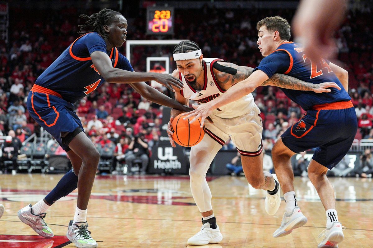 Louisville Cardinals guard J'Vonne Hadley (1) drives under pressure from Bucknell Bison forward Ruot Bijiek (4) and Bucknell Bison guard Achile Spadone (24) during an exhibition game at the KFC Yum! Center in Louisville, Kentucky TuesdayOctober 28, 2025.