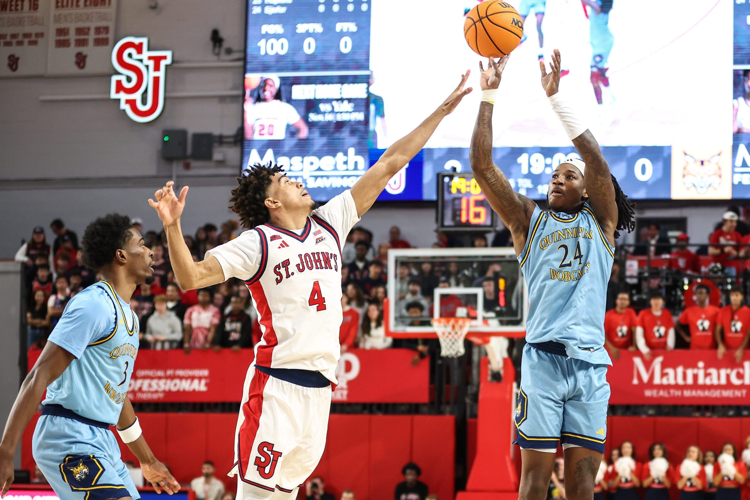 Nov 3, 2025; Queens, New York, USA;  Quinnipiac Bobcats guard Jaden Zimmerman (24) shoots past St. John's Red Storm guard Oziyah Sellers (4) in the first half at Carnesecca Arena. Mandatory Credit: Wendell Cruz-Imagn Images