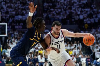 Nov 3, 2025; Storrs, Connecticut, USA; UConn Huskies forward Alex Karaban (11) drives the ball against New Haven Chargers guard/forward Teshaun Steele (14) in the second half at Harry A. Gampel Pavilion. Mandatory Credit: David Butler II-Imagn Images
