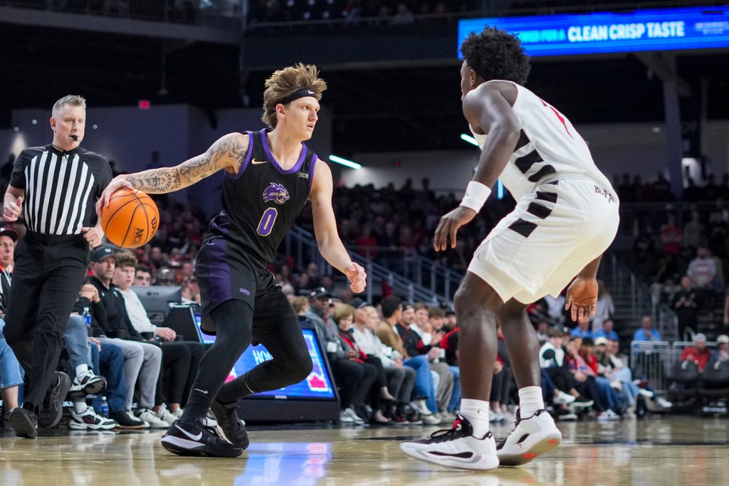 Nov 3, 2025; Cincinnati, Ohio, USA; Western Carolina Catamounts guard Cord Stansberry (0) dribbles the ball against Cincinnati Bearcats guard Keyshuan Tillery (7) in the second half at Fifth Third Arena. Mandatory Credit: Aaron Doster-Imagn Images