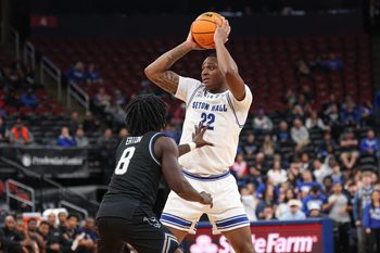 Nov 3, 2025; Newark, New Jersey, USA; Seton Hall Pirates guard Elijah Fisher (22) is guarded by Saint Peter's Peacocks guard Bryce Eaton (8) during the second half at Prudential Center. Mandatory Credit: Vincent Carchietta-Imagn Images