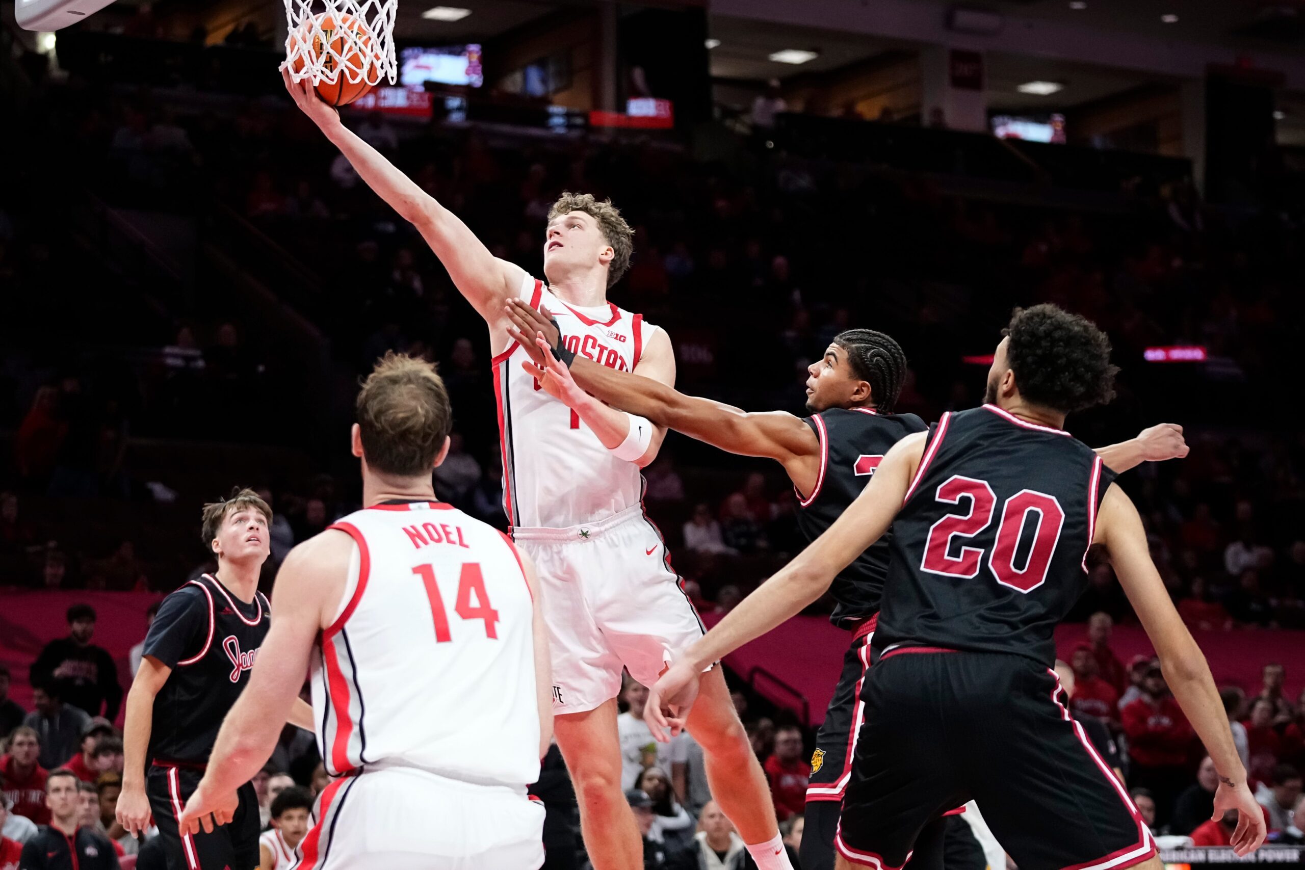 Ohio State Buckeyes center Christoph Tilly (13) shoots around IU Indy Jaguars forward Aiden Miller (23) during the NCAA men's basketball game at Value City Arena in Columbus on Nov. 3, 2025. Ohio State won the season opener 118-102.