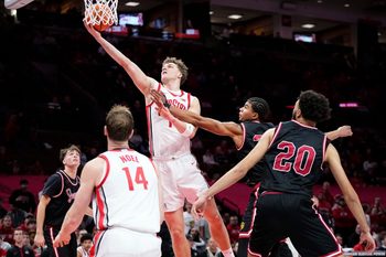 Ohio State Buckeyes center Christoph Tilly (13) shoots around IU Indy Jaguars forward Aiden Miller (23) during the NCAA men's basketball game at Value City Arena in Columbus on Nov. 3, 2025. Ohio State won the season opener 118-102.