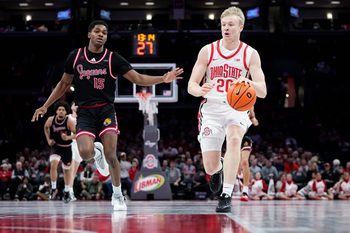 Ohio State Buckeyes forward Colin White (20) dribbles ahead of IU Indy Jaguars guard Matt Compas (15) during the NCAA men's basketball game at Value City Arena in Columbus on Nov. 3, 2025. Ohio State won the season opener 118-102.