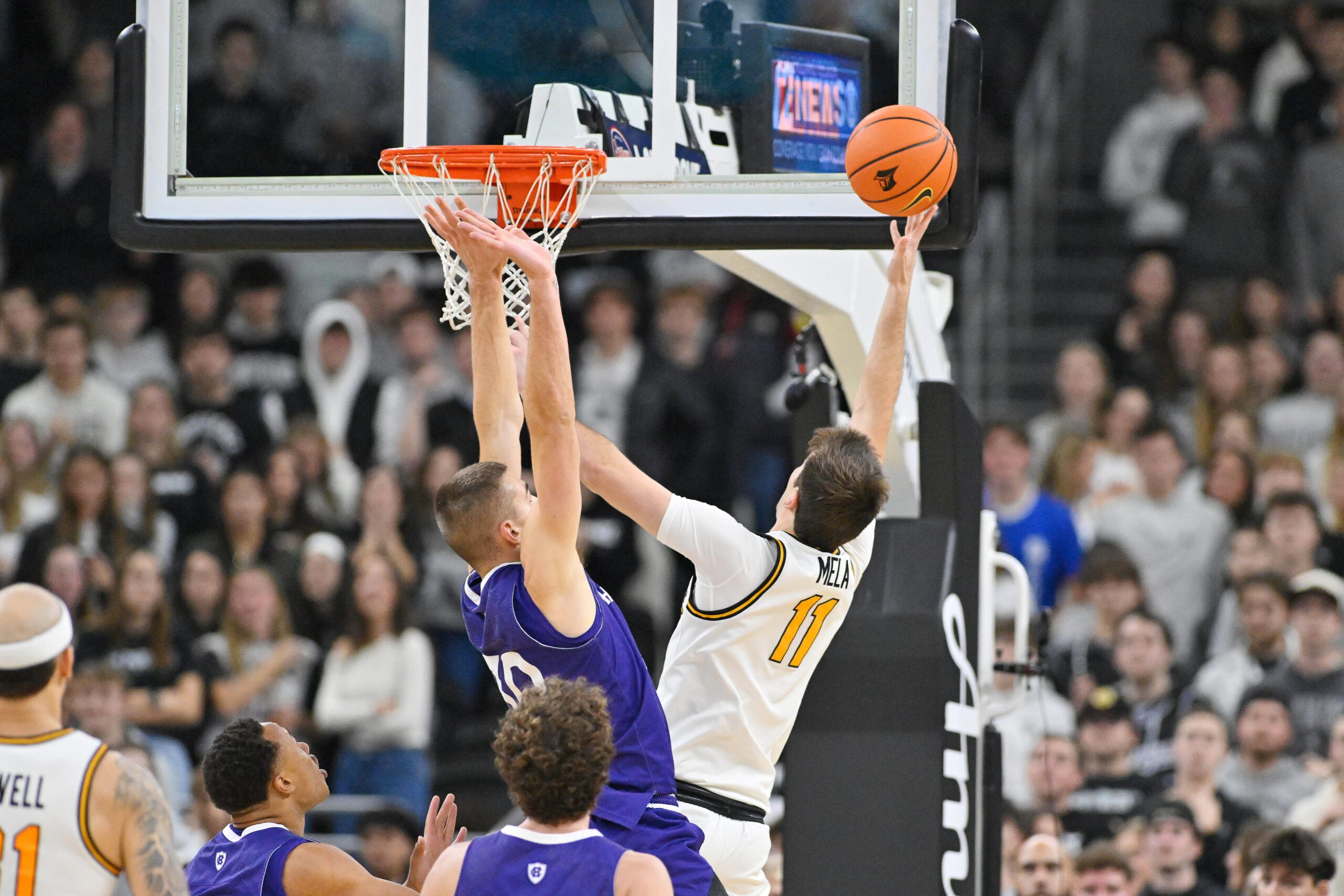 Nov 3, 2025; Providence, Rhode Island, USA; Providence Friars guard Ryan Mela (11) shoots over Holy Cross Crusaders guard Joe Nugent (30) during the second half at Amica Mutual Pavilion. Mandatory Credit: Eric Canha-Imagn Images