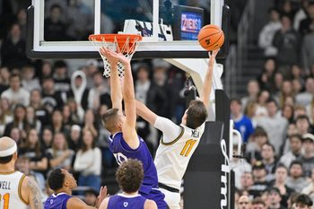 Nov 3, 2025; Providence, Rhode Island, USA; Providence Friars guard Ryan Mela (11) shoots over Holy Cross Crusaders guard Joe Nugent (30) during the second half at Amica Mutual Pavilion. Mandatory Credit: Eric Canha-Imagn Images