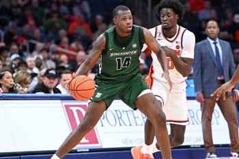 Nov 3, 2025; Syracuse, New York, USA; Binghamton Bearcats center Demetrius Lilley (14) handles the ball as Syracuse Orange forward Sadiq White Jr. (0) defends in the second half at the JMA Wireless Dome. Mandatory Credit: Mark Konezny-Imagn Images