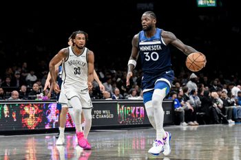 Nov 3, 2025; Brooklyn, New York, USA; Minnesota Timberwolves forward Julius Randle (30) looks to drive against Brooklyn Nets center Nic Claxton (33) during the first half at Barclays Center. Mandatory Credit: John Jones-Imagn Images
