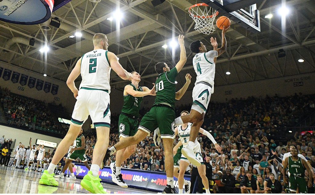 UNCW's #4 Nolan Hodge puts in a layup as UNCW took on Mount Olive Nov. 3, 2025 at Trask Coliseum in Wilmington, N.C. KEN BLEVINS/STARNEWS