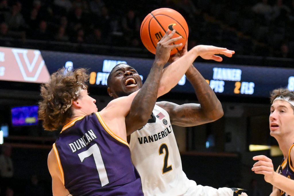 Nov 3, 2025; Nashville, Tennessee, USA; Lipscomb Bisons guard Ethan Duncan (7) fouls Vanderbilt Commodores guard Duke Miles (2) during the second half at Memorial Gymnasium. Mandatory Credit: Steve Roberts-Imagn Images