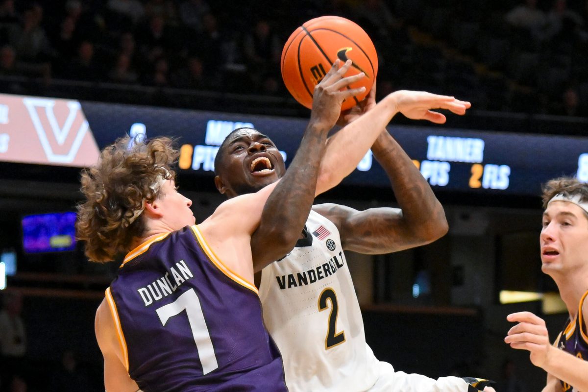 Nov 3, 2025; Nashville, Tennessee, USA; Lipscomb Bisons guard Ethan Duncan (7) fouls Vanderbilt Commodores guard Duke Miles (2) during the second half at Memorial Gymnasium. Mandatory Credit: Steve Roberts-Imagn Images
