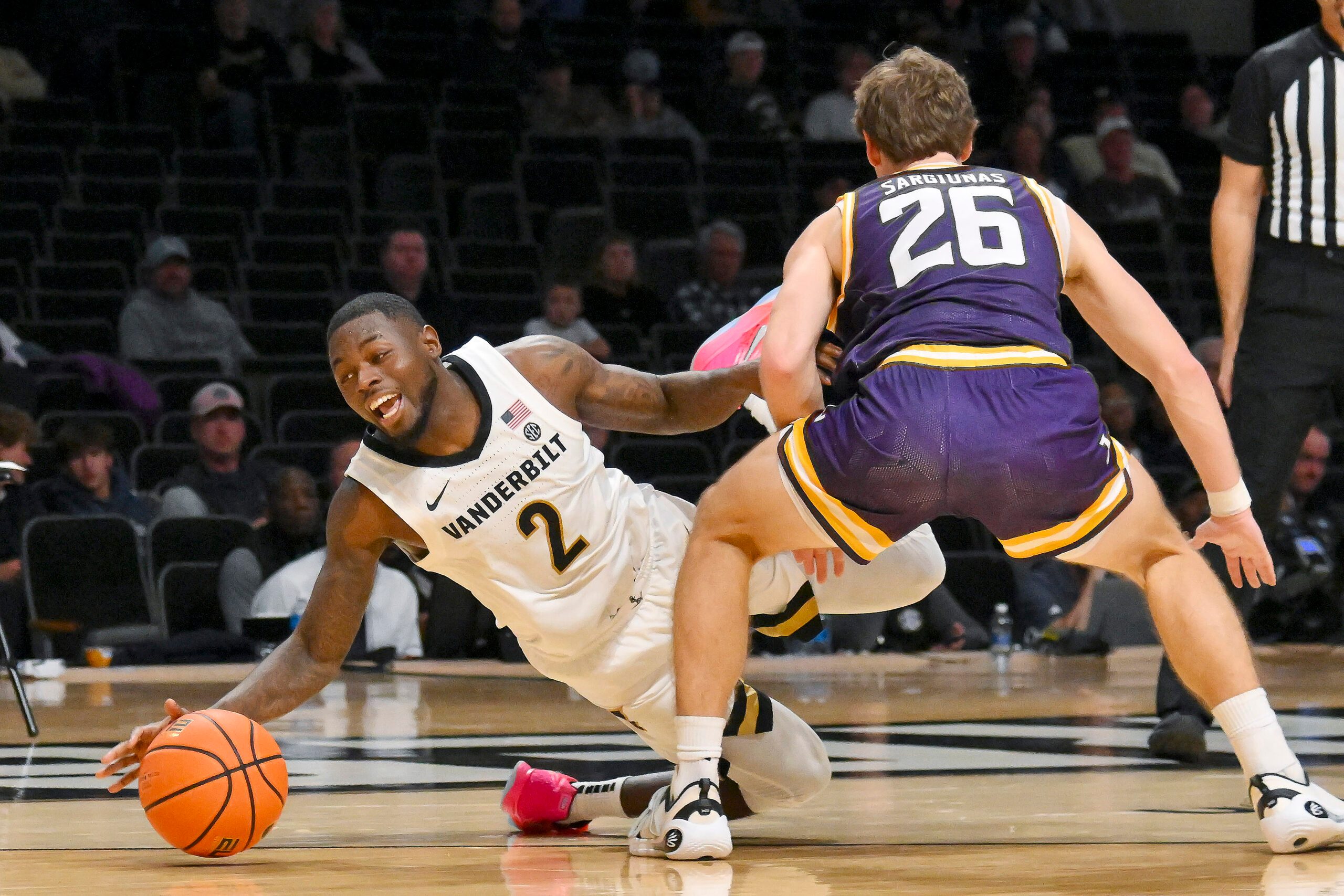 Nov 3, 2025; Nashville, Tennessee, USA;  Lipscomb Bisons forward Titas Sargiunas (26) fouls Vanderbilt Commodores guard Duke Miles (2) during the second half at Memorial Gymnasium. Mandatory Credit: Steve Roberts-Imagn Images