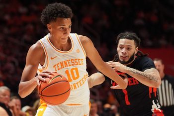 Tennessee forward Nate Ament (10) tries to move past Mercer guard Zaire Williams (1) during an NCAA college basketball game on November 3, 2025, in Knoxville, Tenn.