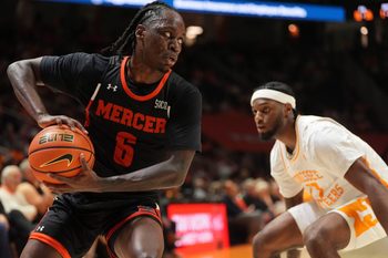 Mercer guard Baraka Okojie (6) moves the ball while guarded by Tennessee guard Amaree Abram (77) in an NCAA college basketball game on November 3, 2025, in Knoxville, Tenn.