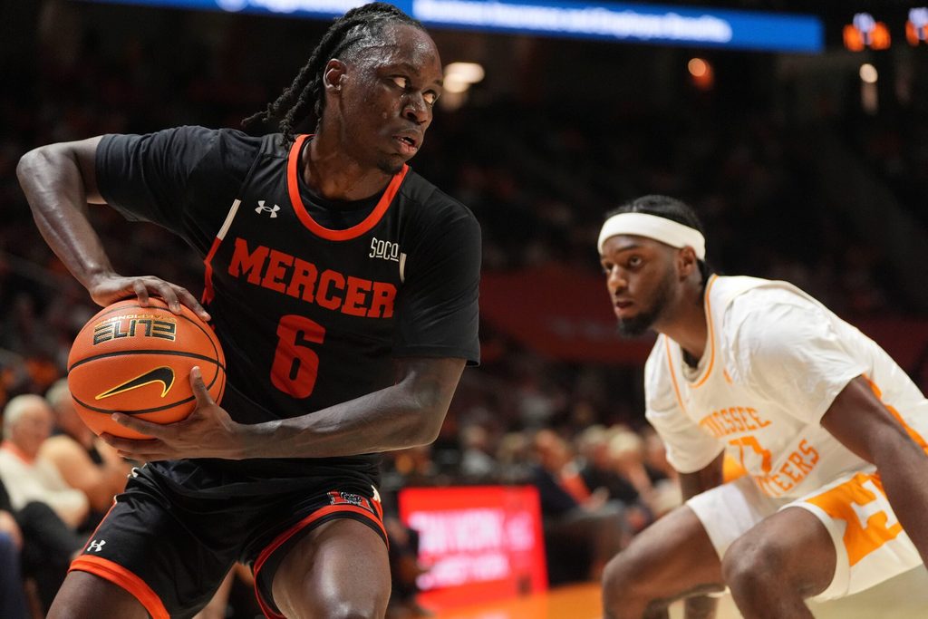 Mercer guard Baraka Okojie (6) moves the ball while guarded by Tennessee guard Amaree Abram (77) in an NCAA college basketball game on November 3, 2025, in Knoxville, Tenn.