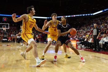 Nov 3, 2025; Ames, Iowa, USA; Iowa State Cyclones guard Nate Heise (0) defends Fairleigh Dickinson Knights guard Eric Parnell (7) at James H. Hilton Coliseum. Mandatory Credit: Reese Strickland-Imagn Images