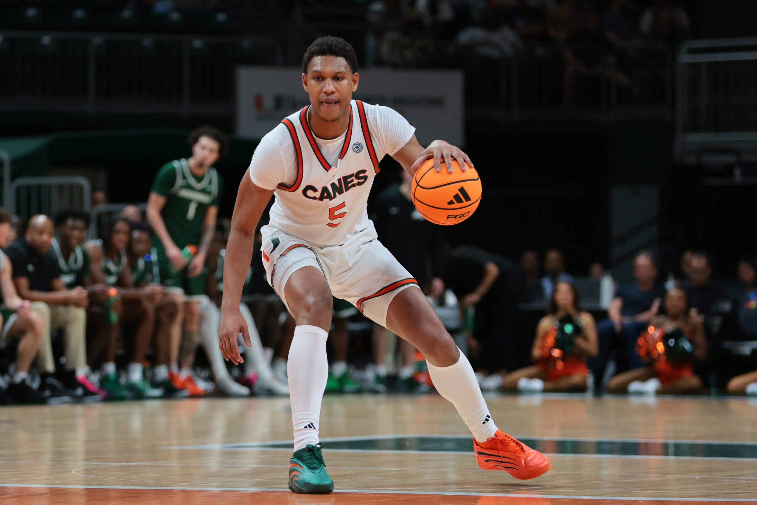 Nov 3, 2025; Coral Gables, Florida, USA; Miami Hurricanes forward Malik Reneau (5) dribbles the basketball against the Jacksonville Dolphins during the second half at Watsco Center. Mandatory Credit: Sam Navarro-Imagn Images