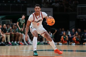 Nov 3, 2025; Coral Gables, Florida, USA; Miami Hurricanes forward Malik Reneau (5) dribbles the basketball against the Jacksonville Dolphins during the second half at Watsco Center. Mandatory Credit: Sam Navarro-Imagn Images