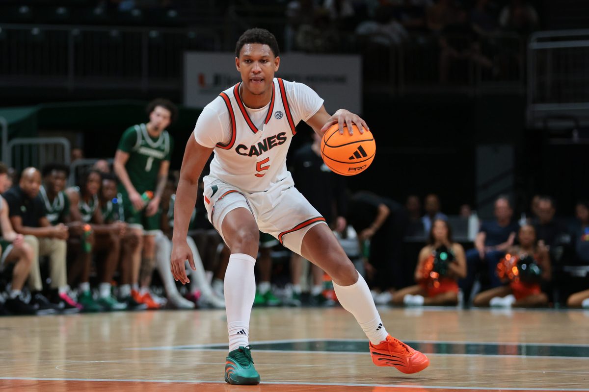 Nov 3, 2025; Coral Gables, Florida, USA; Miami Hurricanes forward Malik Reneau (5) dribbles the basketball against the Jacksonville Dolphins during the second half at Watsco Center. Mandatory Credit: Sam Navarro-Imagn Images