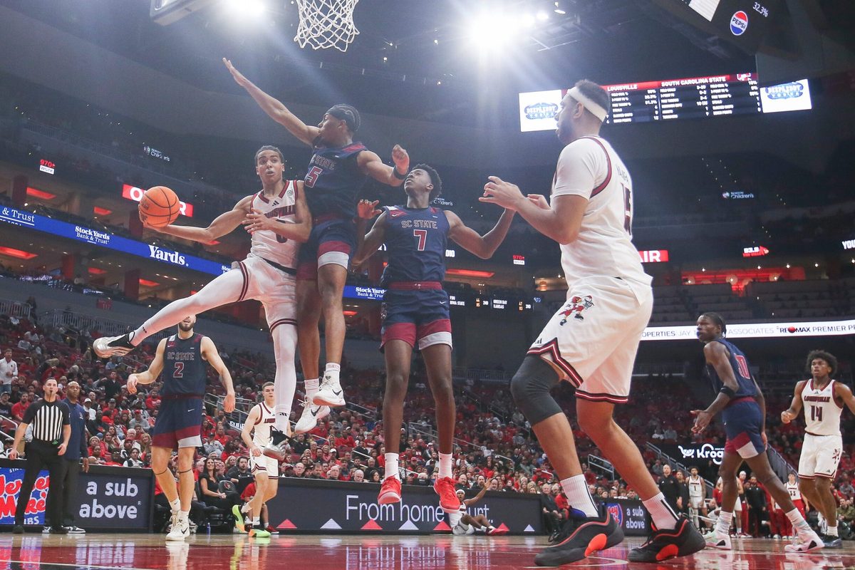 Louisville Cardinals guard Mikel Brown Jr. (0) passes around South Carolina State Bulldogs guard Jr. Owen Bronston (5) as the Cards led 59-15 at the half at the KFC Yum! Center Monday night, Nov. 3, 2025.