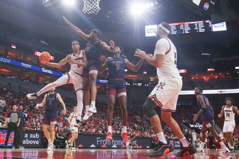 Louisville Cardinals guard Mikel Brown Jr. (0) passes around South Carolina State Bulldogs guard Jr. Owen Bronston (5) as the Cards led 59-15 at the half at the KFC Yum! Center Monday night, Nov. 3, 2025.