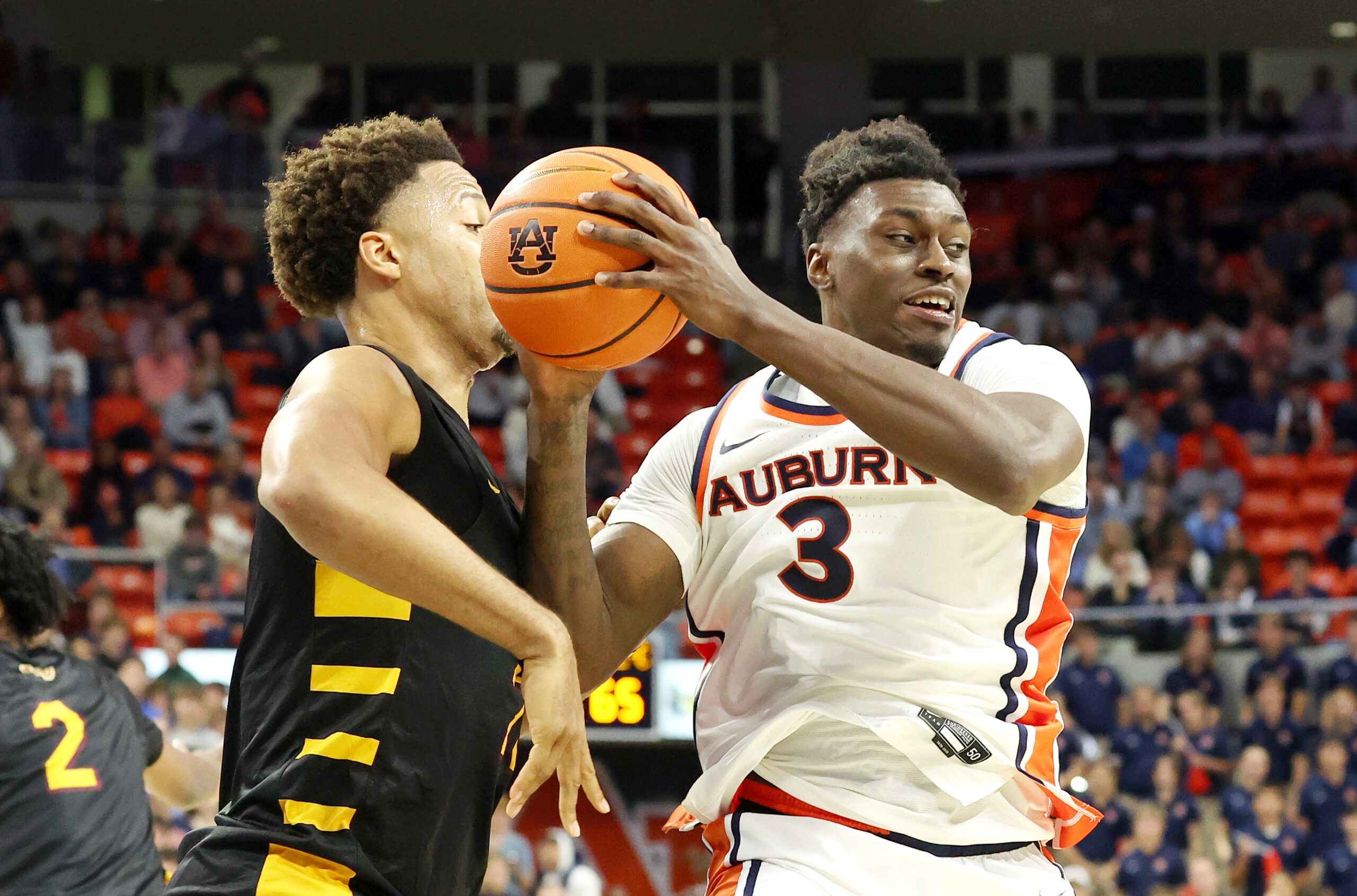 Nov 3, 2025; Auburn, Alabama, USA;  Auburn Tigers forward Keshawn Murphy (3) grabs a rebound over Bethune-Cookman Wildcats forward Daniel Rouzan (23) during the second half at Neville Arena.  Mandatory Credit: John Reed-Imagn Images