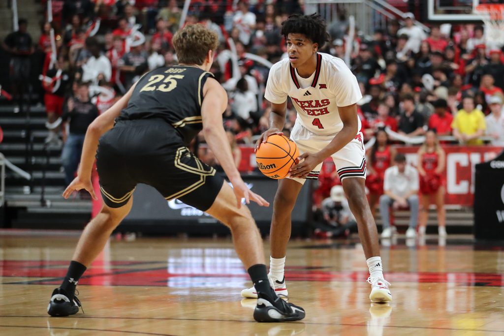 Nov 4, 2025; Lubbock, Texas, USA; Texas Tech Red Raiders guard Christian Anderson (4) dribbles the ball against Lindenwood Lions forward Todd Bieg (25) in the second half at United Supermarkets Arena. Mandatory Credit: Michael C. Johnson-Imagn Images