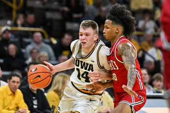 Nov 4, 2025; Iowa City, Iowa, USA; Iowa Hawkeyes guard Bennett Stirtz (14) controls the ball as Robert Morris Colonials guard Albert Vargas (20) defends during the second half at Carver-Hawkeye Arena. Mandatory Credit: Jeffrey Becker-Imagn Images