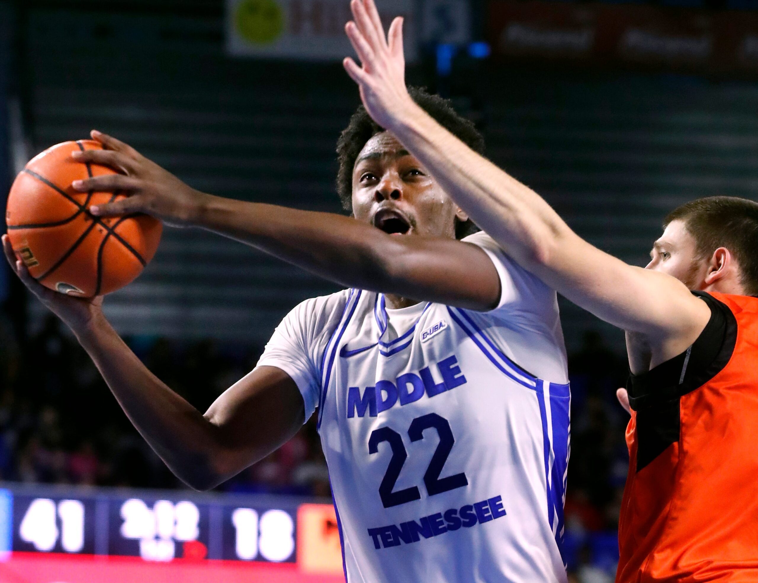 Middle Tennessee guard Kamari Lands (22) goes up for a shot as Milligan guard Sergej Cvetkovic (13) guards him during the Men's college basketball game at Murphy Center on Wednesday, Nov. 5, 2025.