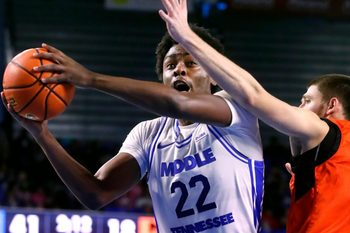 Middle Tennessee guard Kamari Lands (22) goes up for a shot as Milligan guard Sergej Cvetkovic (13) guards him during the Men's college basketball game at Murphy Center on Wednesday, Nov. 5, 2025.
