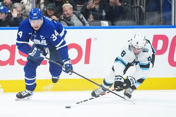Nov 5, 2025; Toronto, Ontario, CAN; Toronto Maple Leafs center Auston Matthews (34) battles for the puck with Utah Mammoth center Nick Schmaltz (8) during the first period at Scotiabank Arena. Mandatory Credit: Nick Turchiaro-Imagn Images